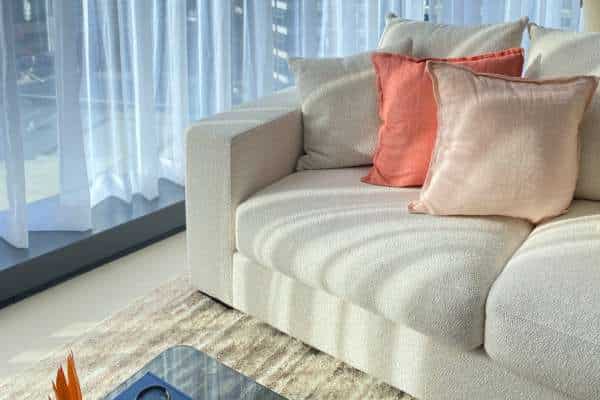 Add A Statement Pillow For Visual Interest in Mix And Match Pillows on A Sofa