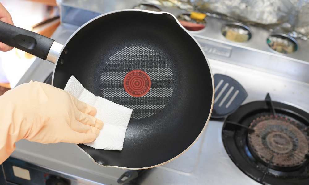 A Dish Towel To Remove Melted fabric From Cookware