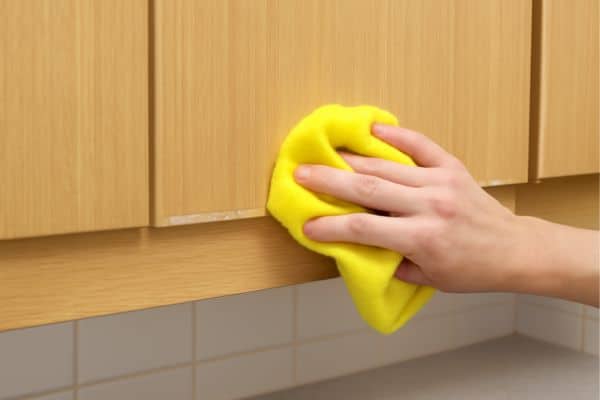 Clean the Surface To Fix Peeling Laminate Cabinets